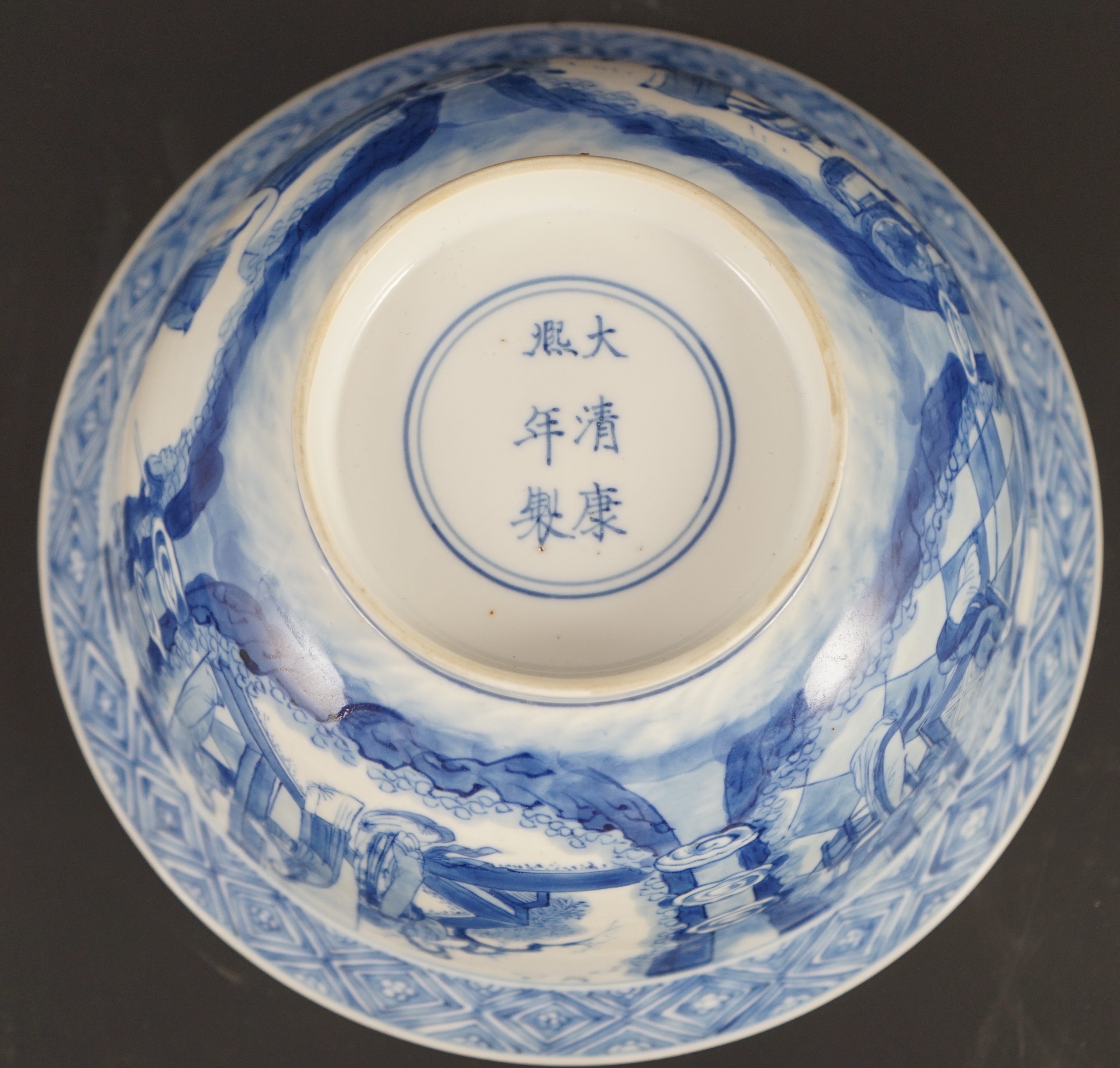 A fine Chinese blue and white ‘Xi Xiang Ji’ bowl, Kangxi six character mark and of the period (1662-1722) 19.9cm diameter, wood stand